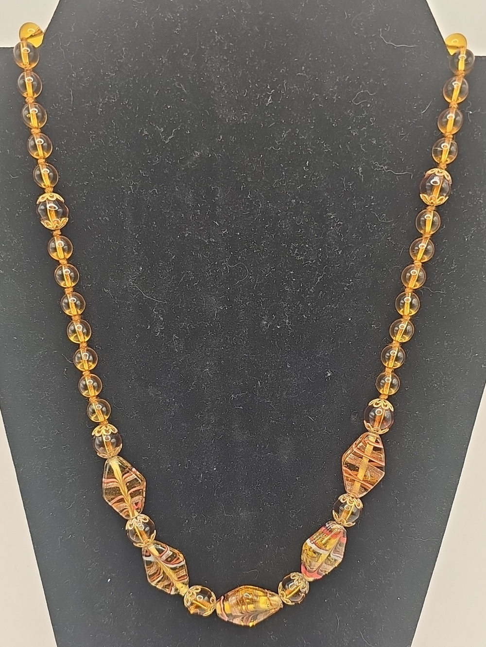 These an arrangement of vintage amber-toned glass beads I Beleive They Are Chech